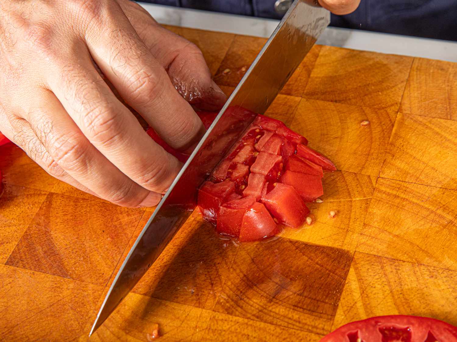 Overhead view of dicing tomatoes