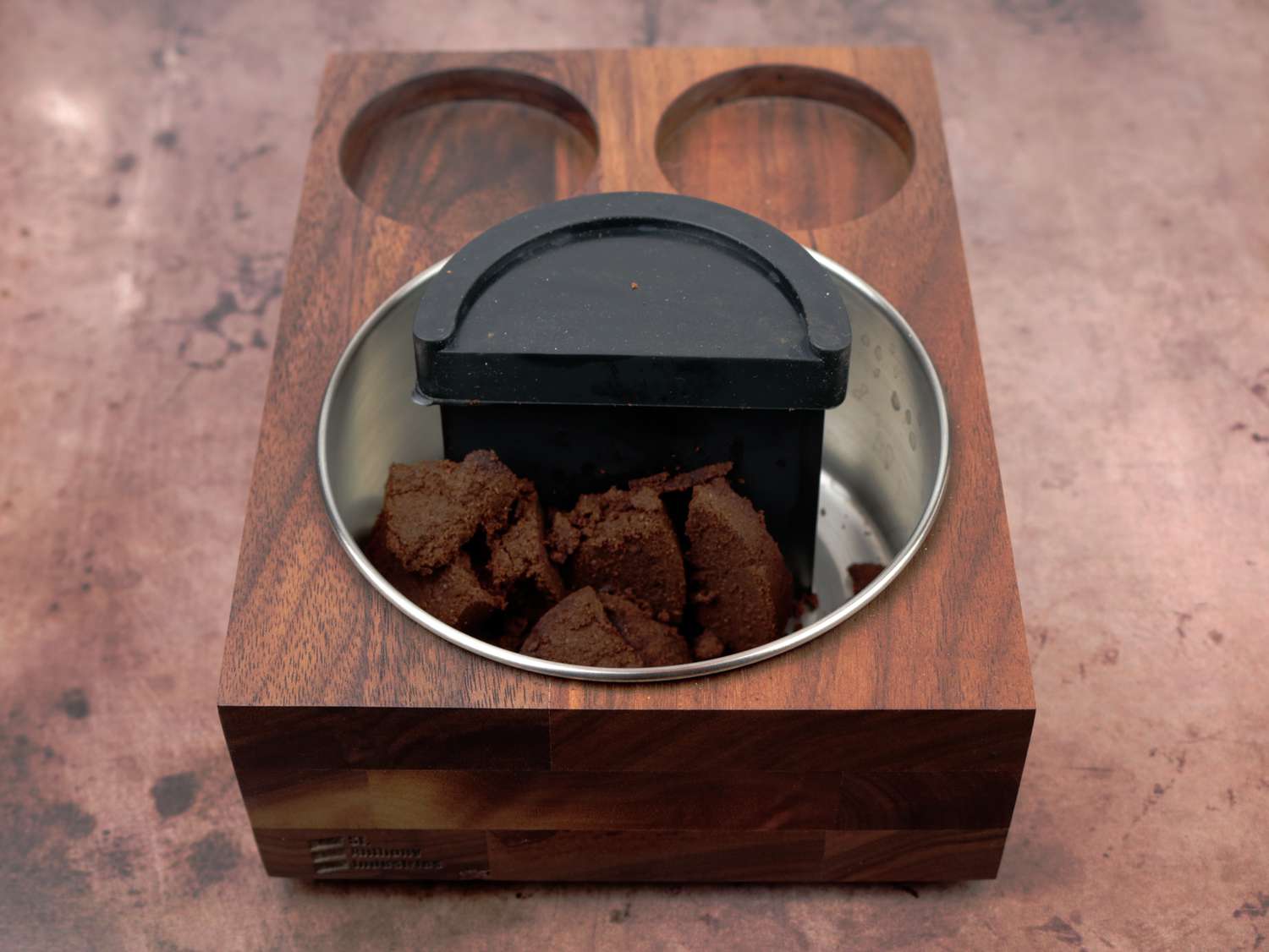 a knock box with a shallow bin full after only two espresso pucks