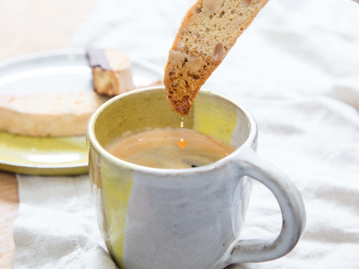A hot cup of coffee with biscotti.