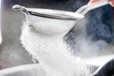 sifting flour into a bowl