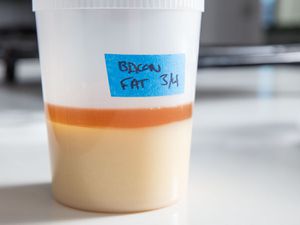 A container of bacon fat, labeled with a date.