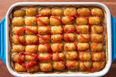 overhead view of tater tot hot dish drizzled with ketchup