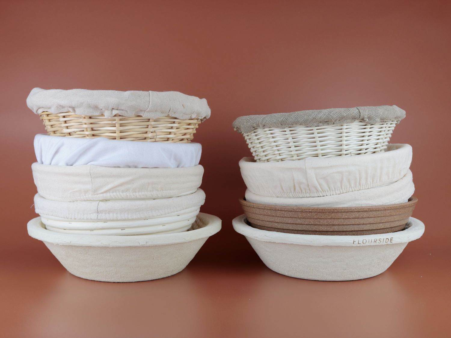 ten bread proofing baskets stacked on top of each other in two piles