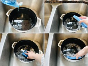 A person scrubs the interior of a dutch oven with dish soap, water, and a sponge.