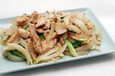 Platter of stir-fried chicken with scallions and ginger