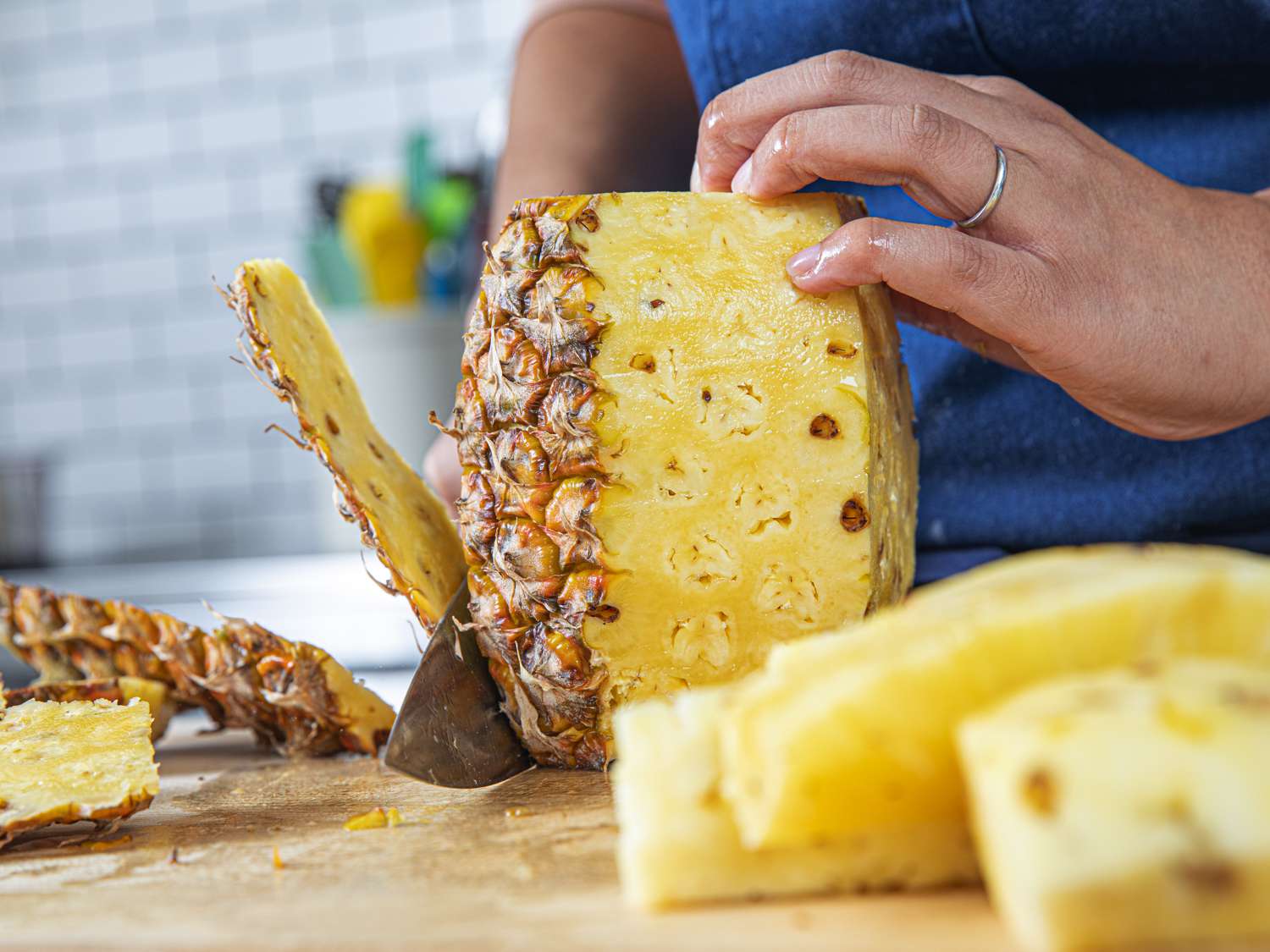 Cutting off the skin of a pineapple
