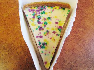 A slice of Popeye's Mardi Gras cheesecake.