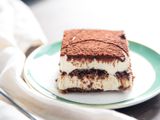 A slice of rich and creamy tiramisu on a dessert plate.