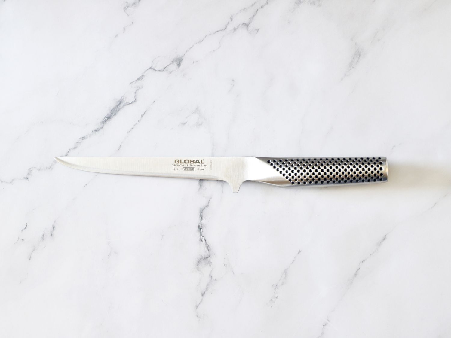 global boning knife on marble countertop