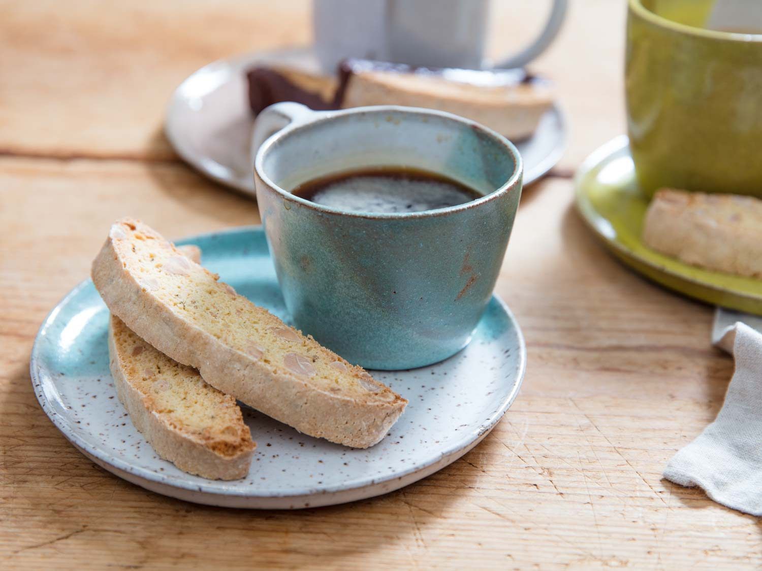 Biscotti and espresso on a saucer.