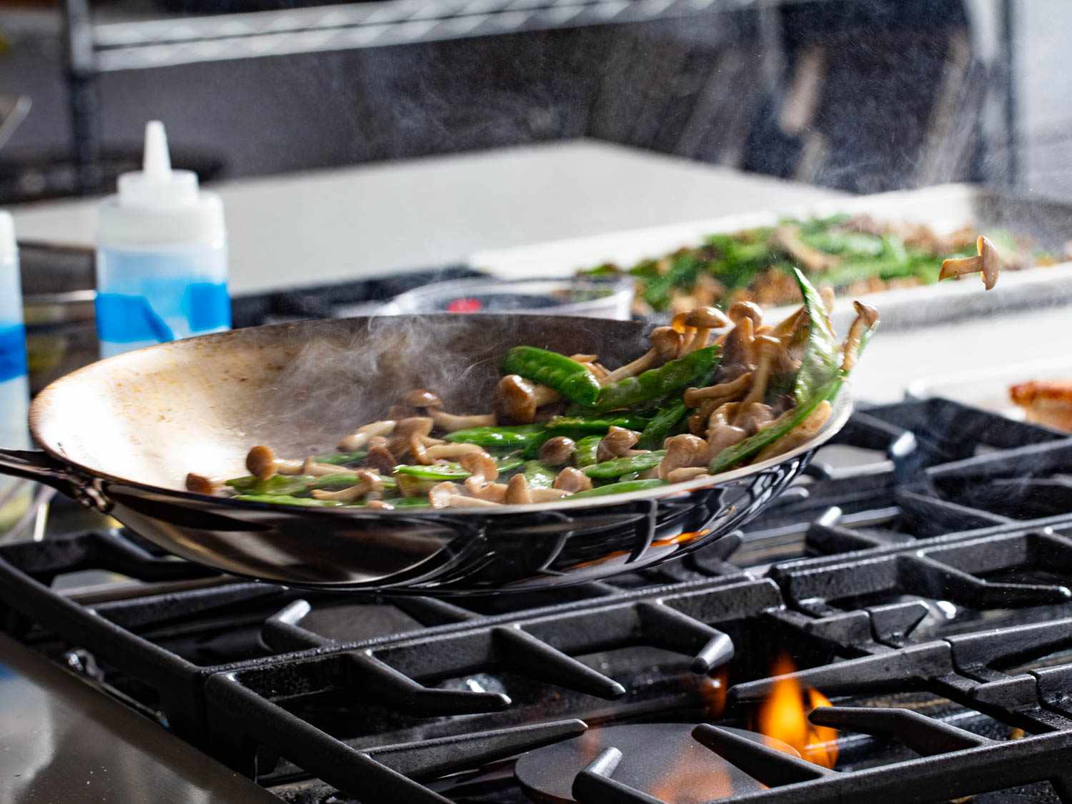 Food tossed in skillet