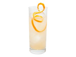 The Number 8, a ginger liqueur-based cocktail in a Collins glass with a long twist of grapefruit peel.