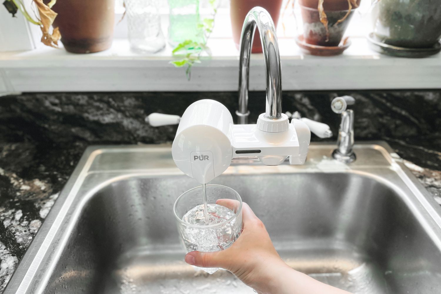 holding a glass under a filter