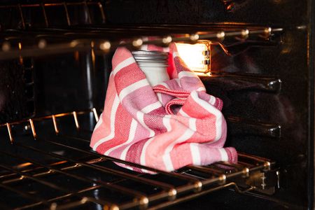 包装你的酸奶毛巾和设置a turned-off oven with the light on can help keep it just warm enough.