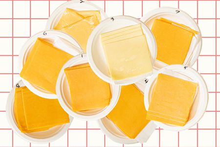 A pile of cheeses on a checkered backdrop