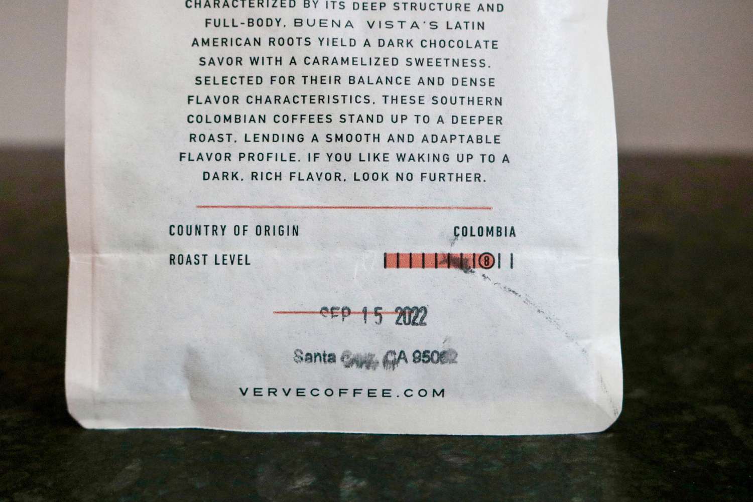 a closeup look at the back of a coffee bean's bag that shows its country of origin and roast level