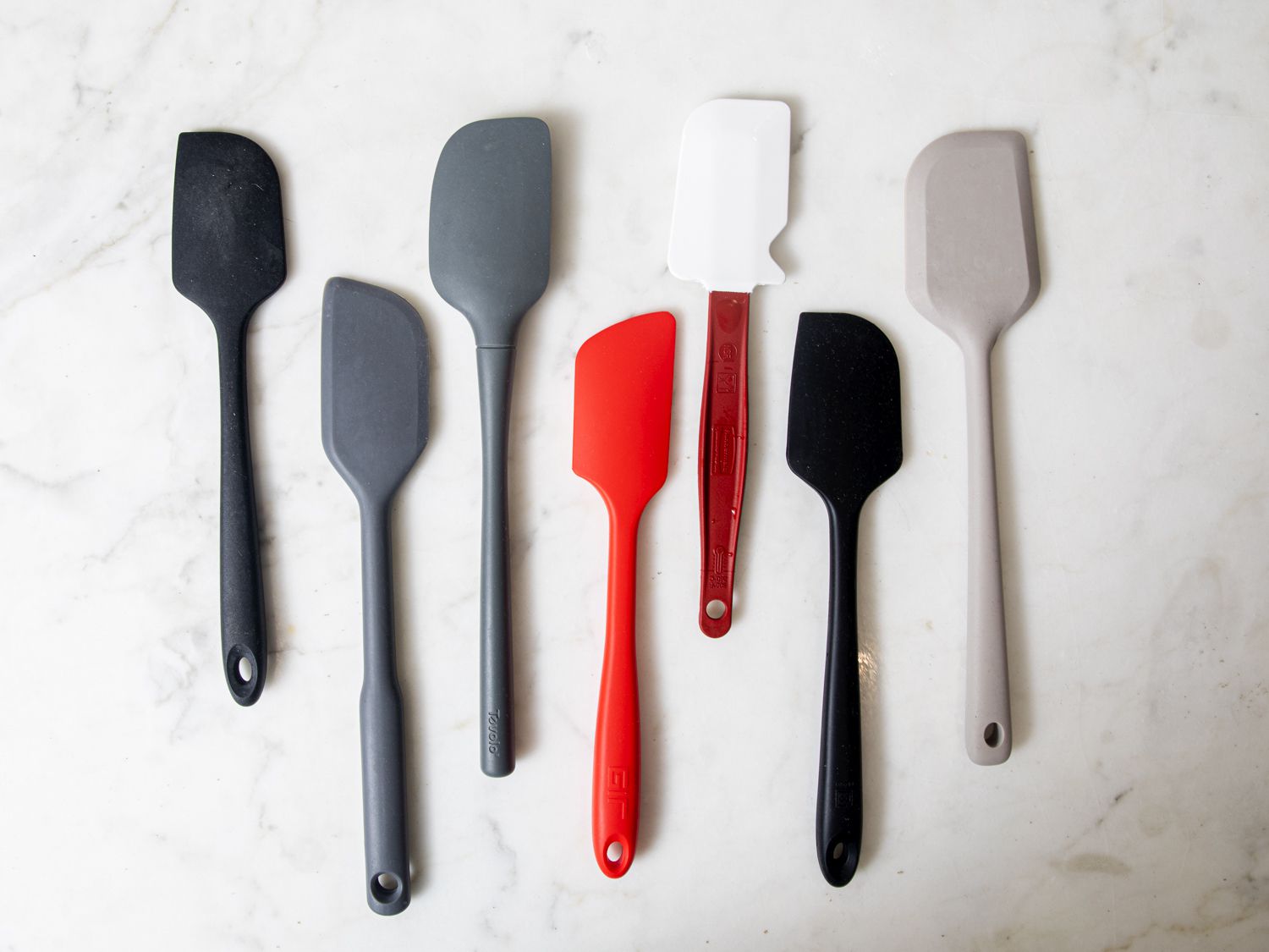 a group of silicone spatulas on a marble surface