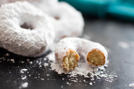 Closeup of homemade mini donettes covered in powdered sugar