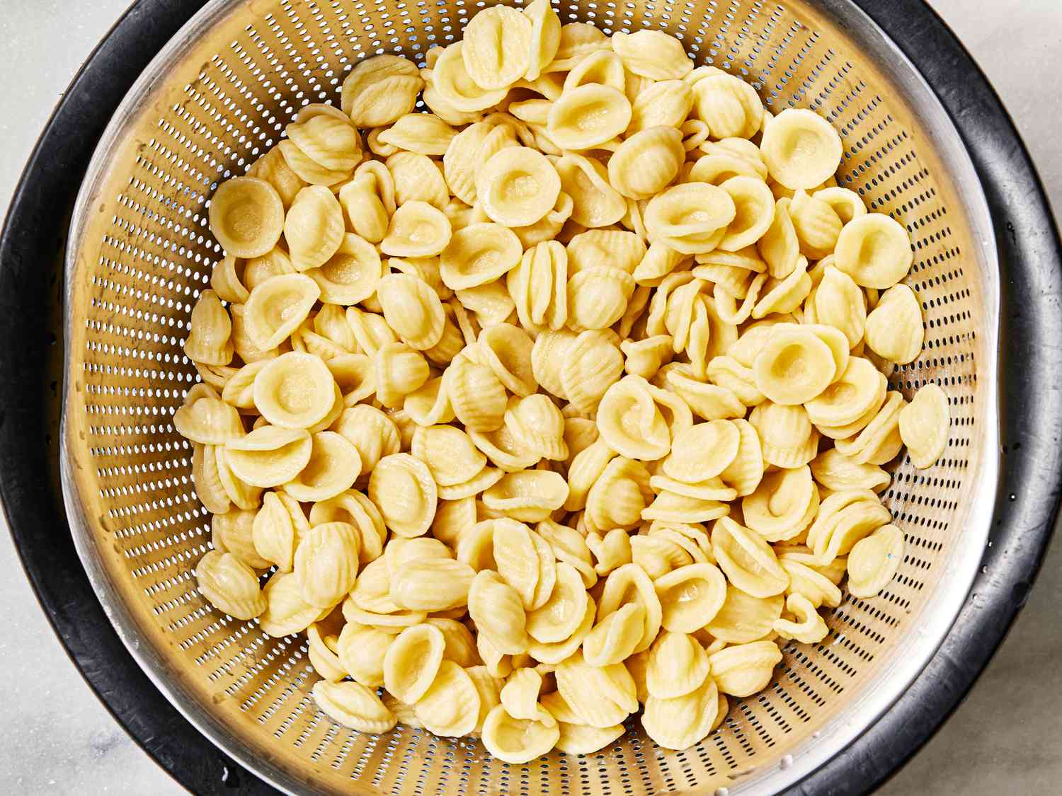 Overhead view of pasta in a collander