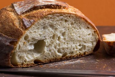 A closeup of a cut loaf of simple crusty white bread.