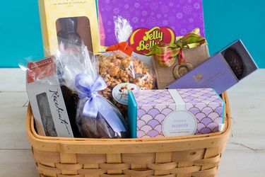 A basket of different candies and treats for Easter.