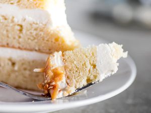 A forkful of coconut layer cake with creamy coconut frosting