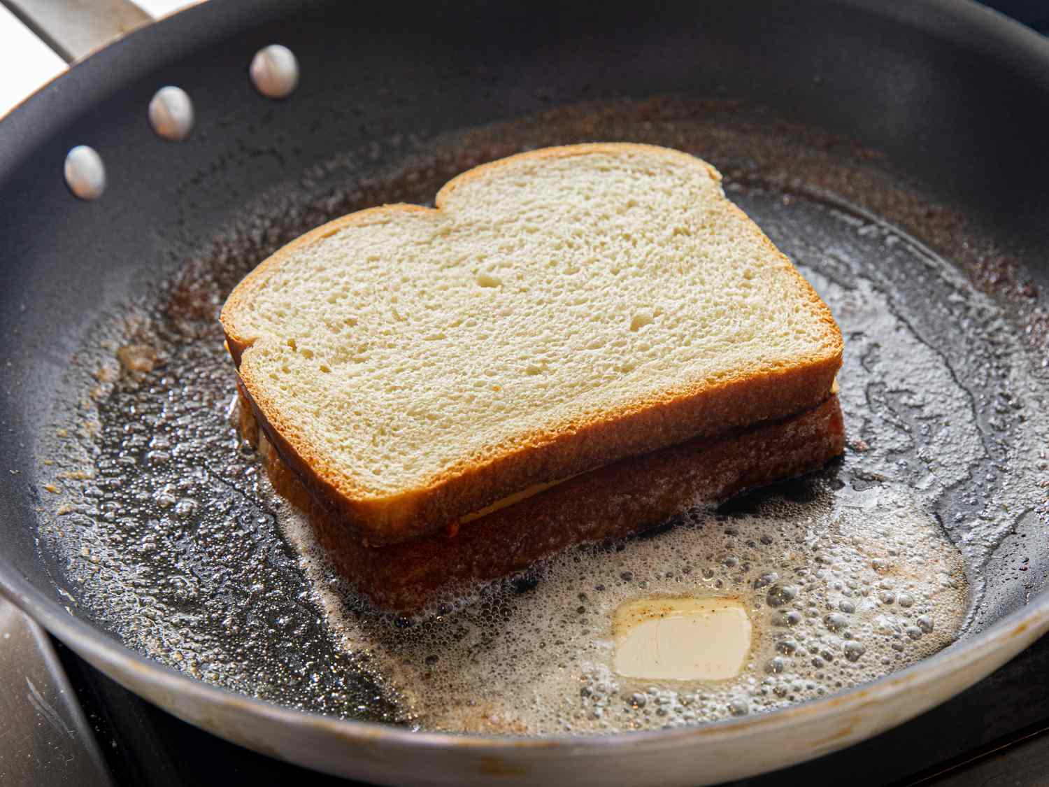 Compiled sandwich being toasted again in the pan