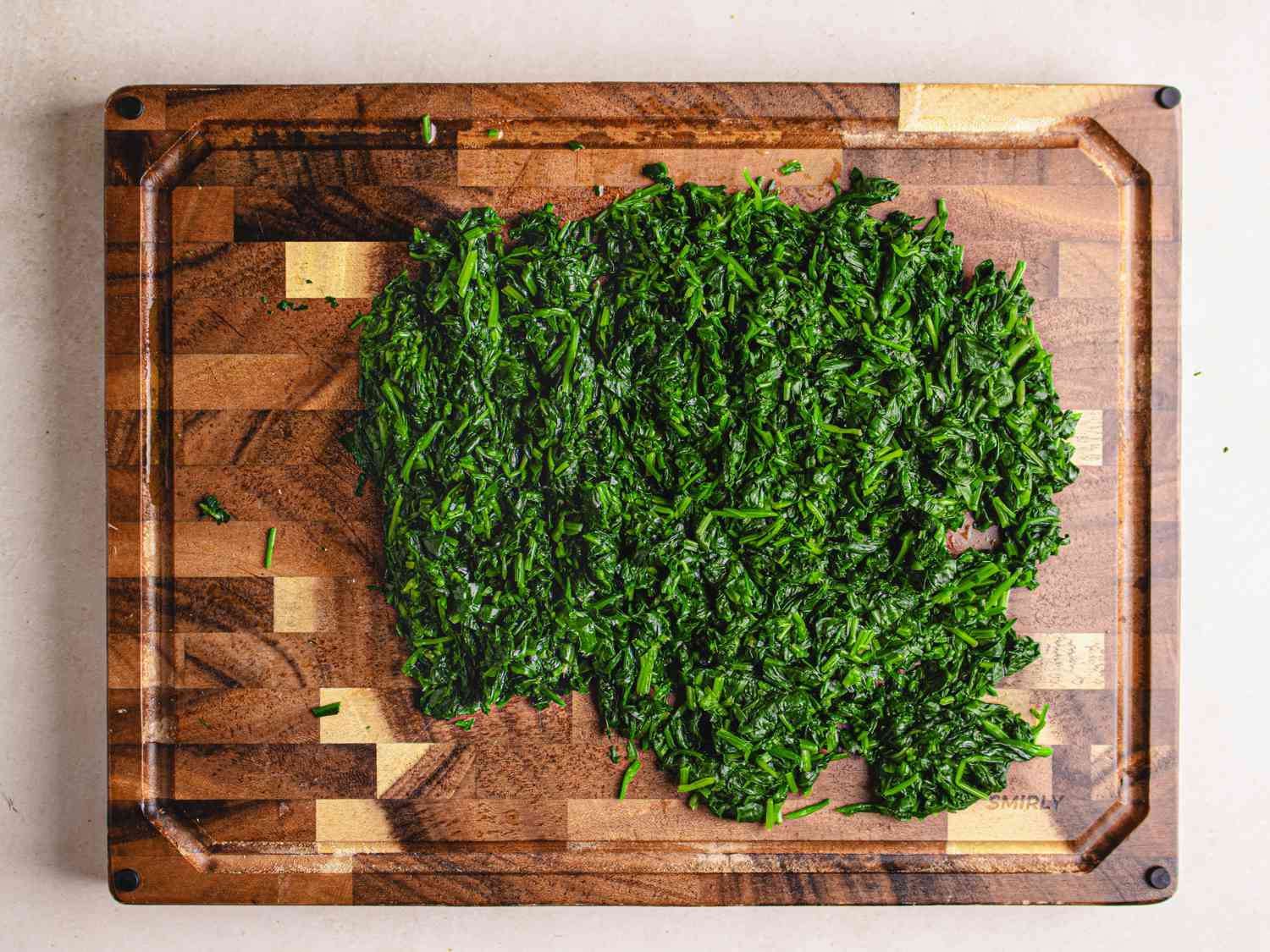 Overhead view of greens chopped on a cutting board