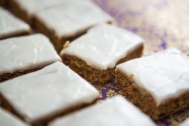 Rows of brown cookie squares glazed with white icing