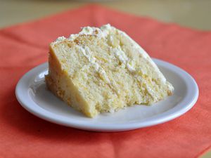 A slice of pig pickin' cake, served on white dessert plate.