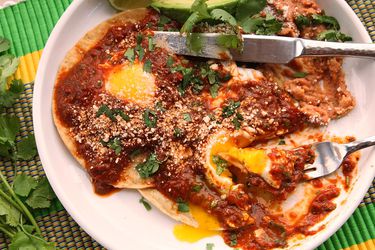 A plate of homemade huevos racheros with tomato chili salsa