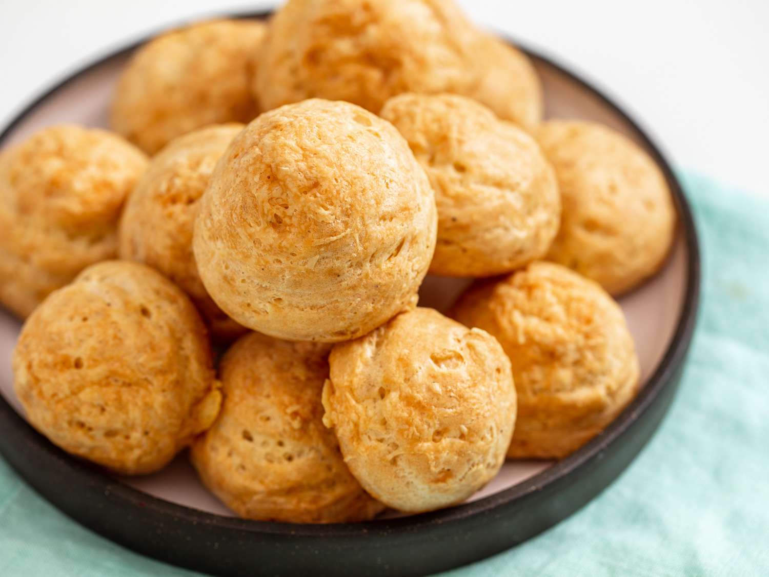 A pile of gougères resting on a plate