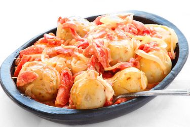 Papas Chorreadas (Colombian Potatoes with Cheese and Tomato Sauce)