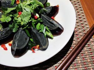 Overhead view of century egg salad, served on a plate.