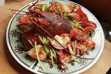 A plate of Cantonese-style lobster with ginger and scallions.