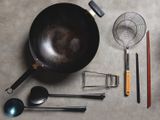 A top-down view of a wok and accessories arranged neatly on a table