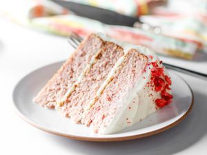 Wedge of strawberry layer cake on a white plate