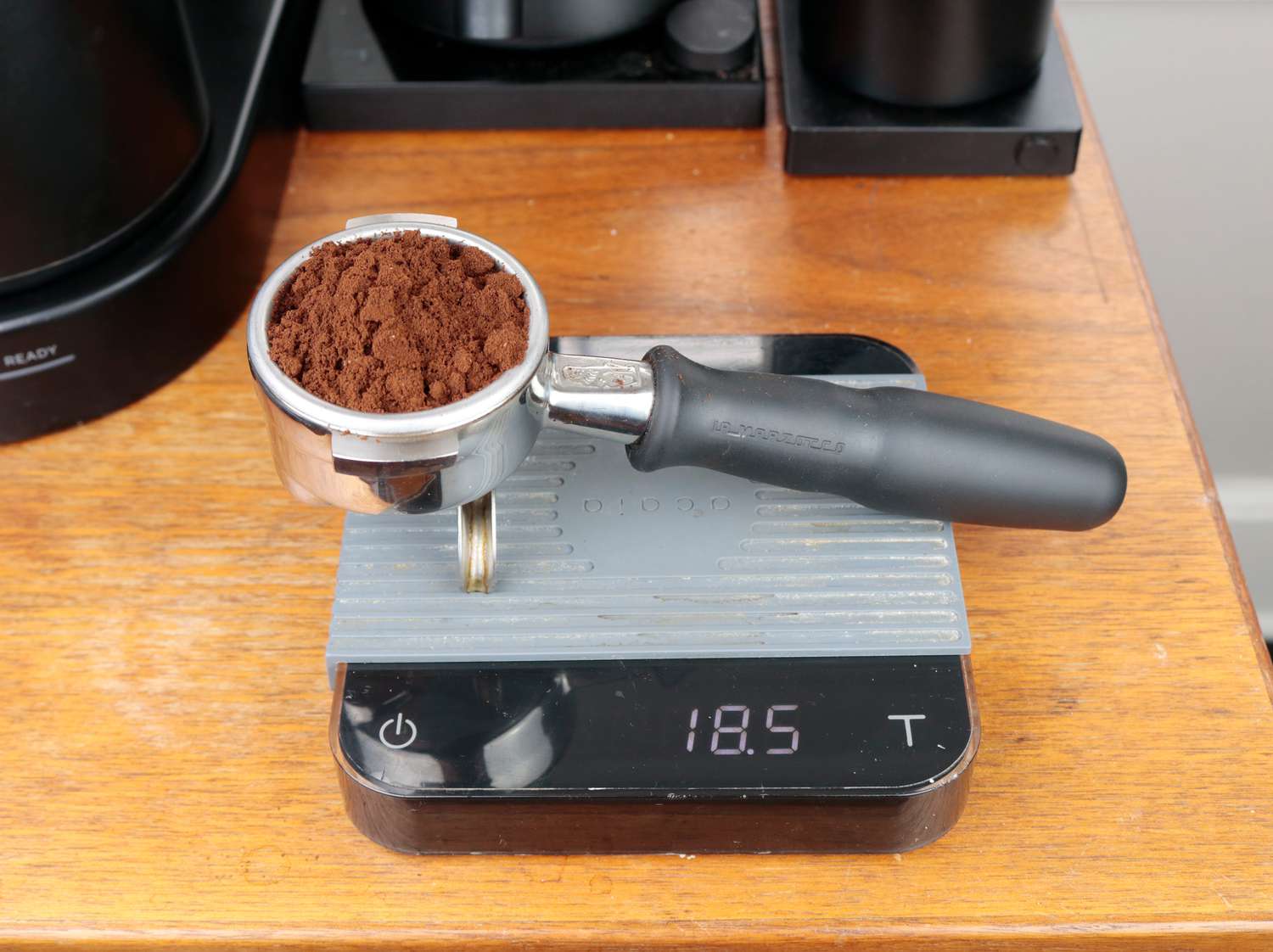 a portafilter on a scale with coffee in the basket