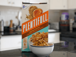 Box of General Mills Plentifull Cereal on a counter with a bowl filled with the cereal in the foreground