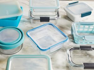 several food storage containers on a marble surface
