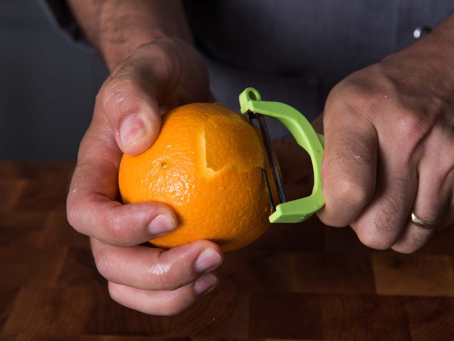 Peeling the zest from an orange.
