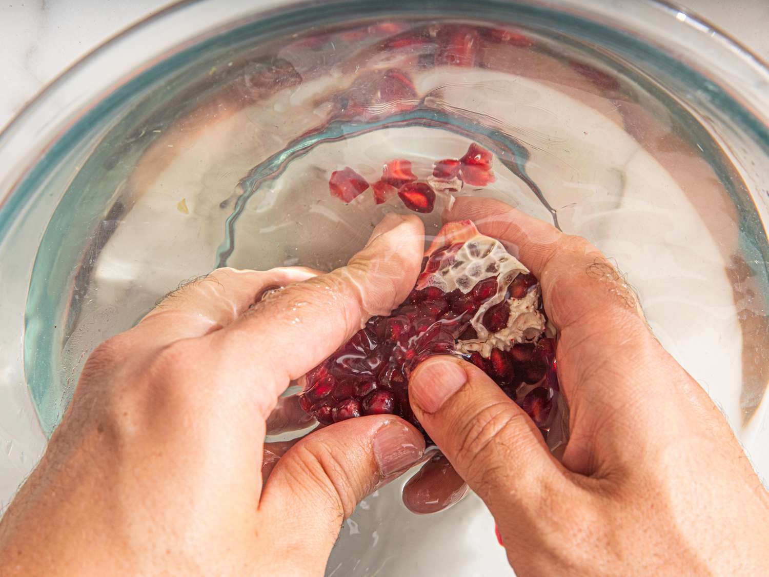 Overhead view of pomegranate section submerged in water