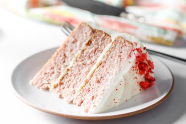 Wedge of strawberry layer cake on a white plate