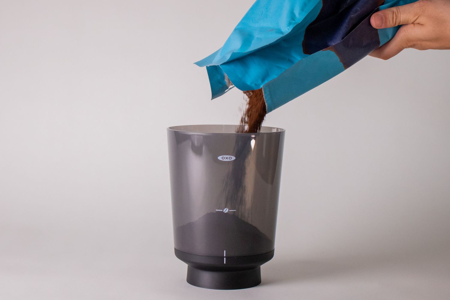 Pouring Coffee Grounds into OXO Cold Brew Coffee Maker