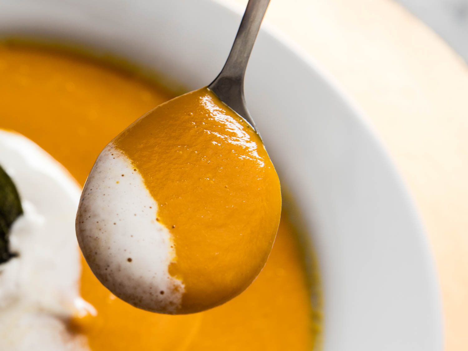 Close up photo of spoonful of butternut squash soup.