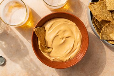 The Best Vegan Nacho Cheese Sauce in a bowl, served with chips