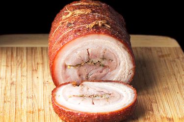 cross-section frontal view of deep-fried pork belly porchetta sliced