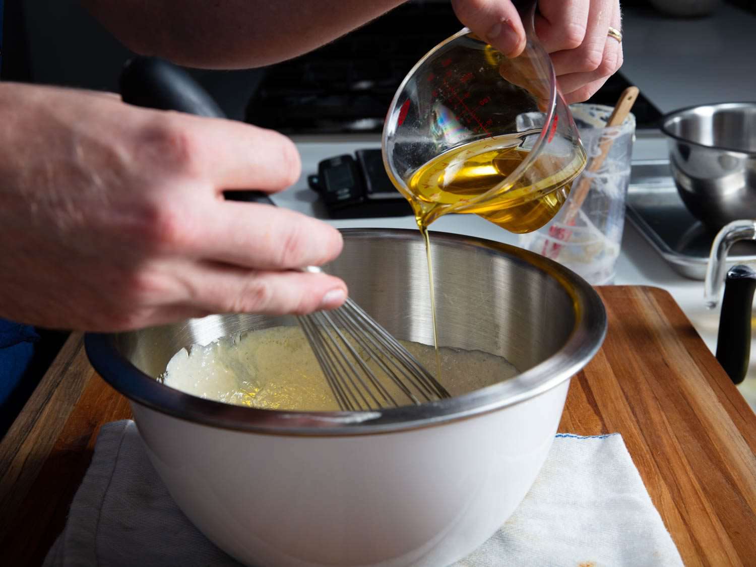 将橄榄油搅拌到汤汁的侧视图。