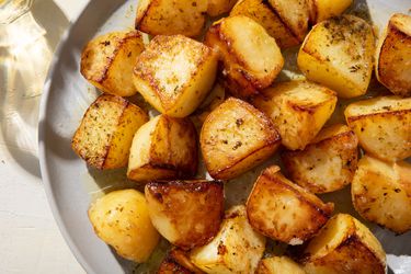 Closeup of a serving plate of Greek lemon potatoes.