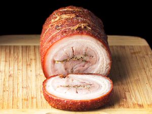 cross-section frontal view of deep-fried pork belly porchetta sliced